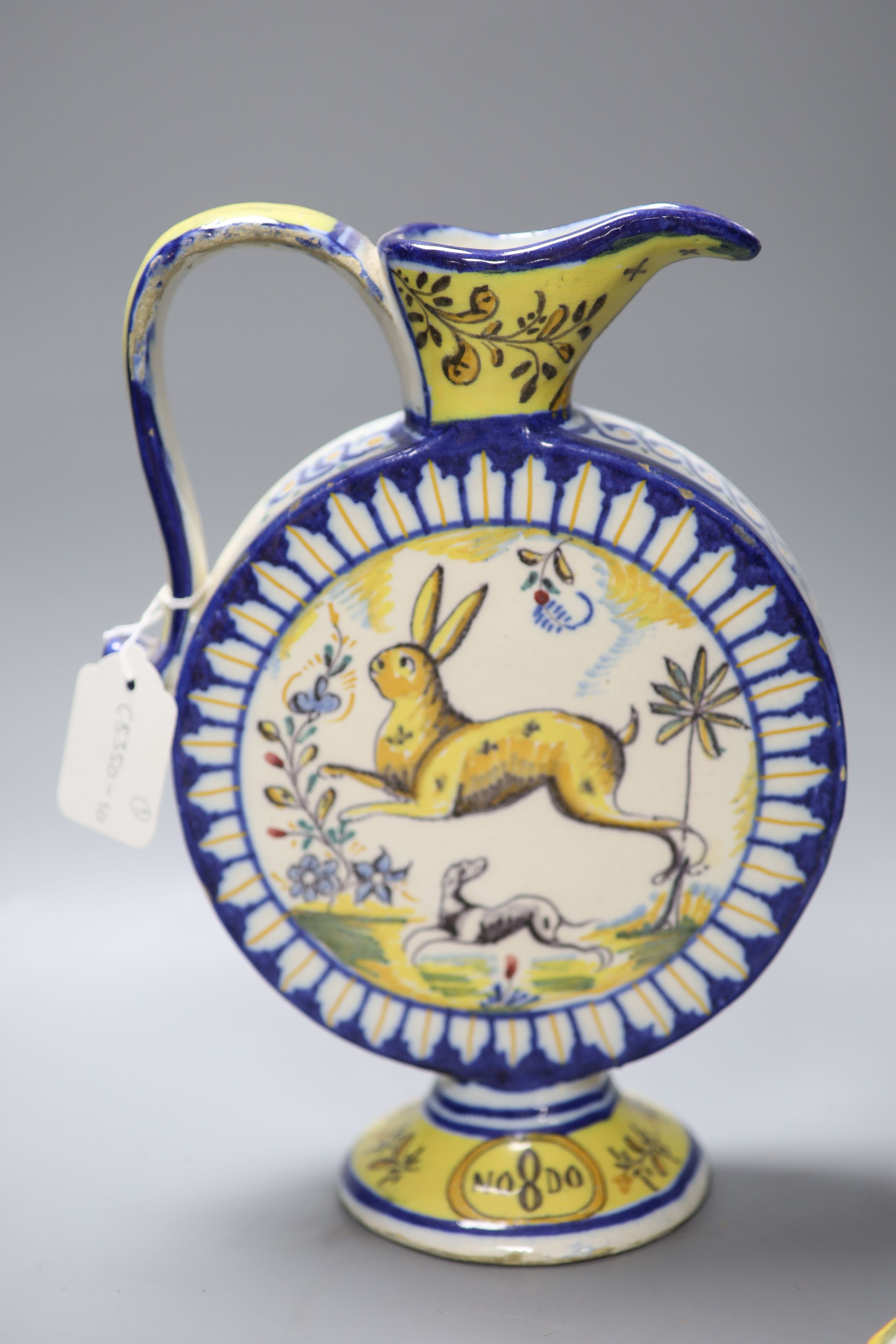 An Italian maiolica flask, height 30cm, and a pair of French faience candlesticks